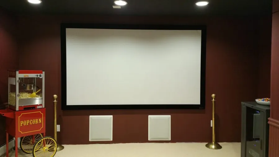 Dedicated home theater with projection screen and in-wall speakers