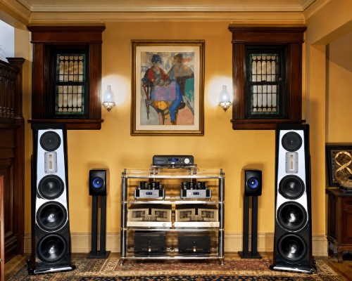One of the Audio Intellect sound rooms: tall floor-standing speakers either side of an equipment rack, under a framed painting